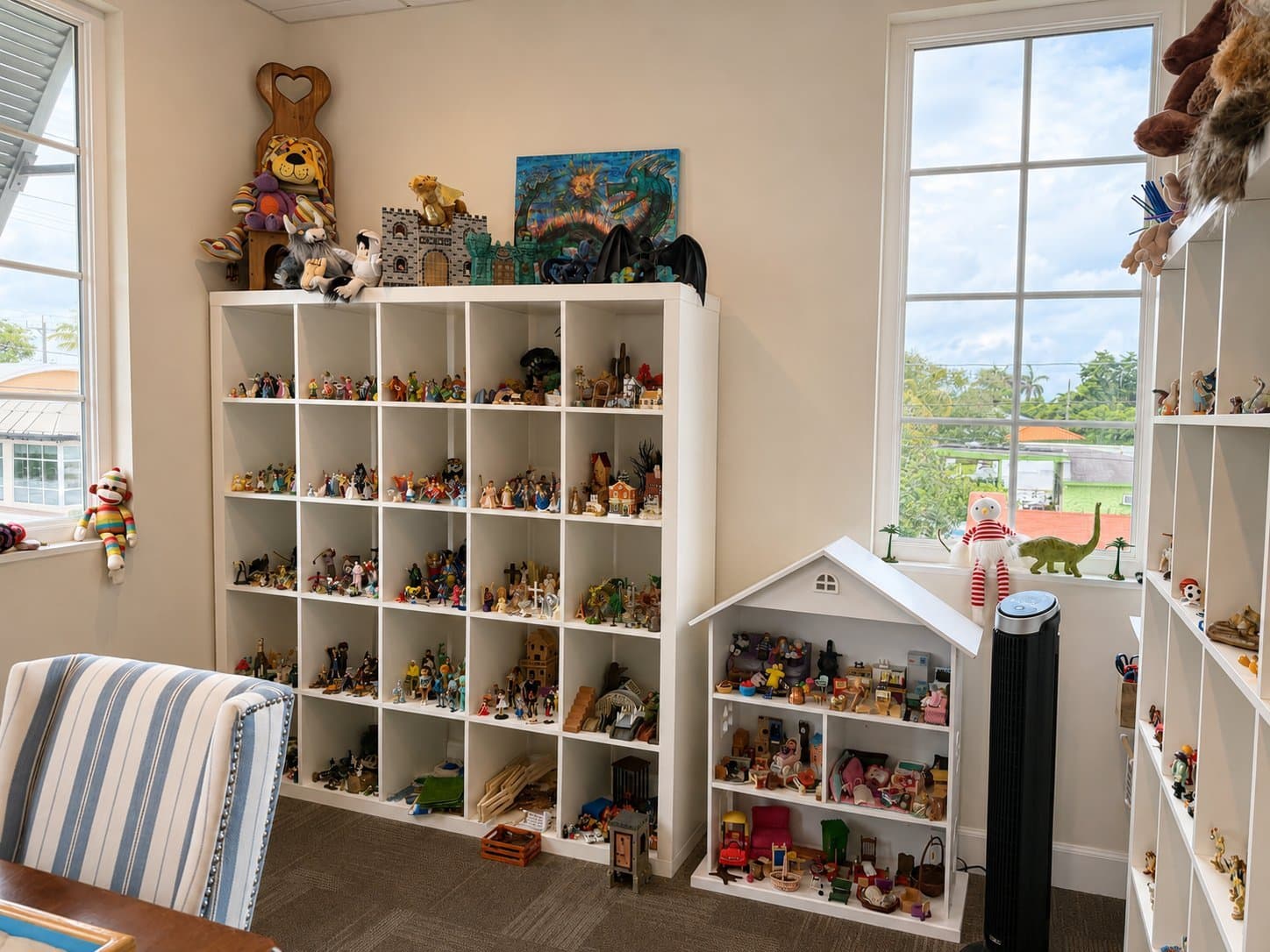 Shelves of figurines and miniatures used in Dr. Parsons' sand tray therapy practice in Delray Beach.